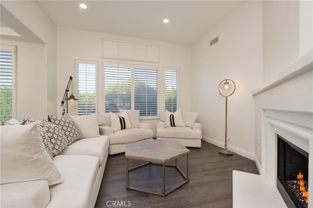 3120 Tara, Costa Mesa, CA 92626 - living area featuring a warm lit fireplace, dark wood-style floors, and recessed lighting