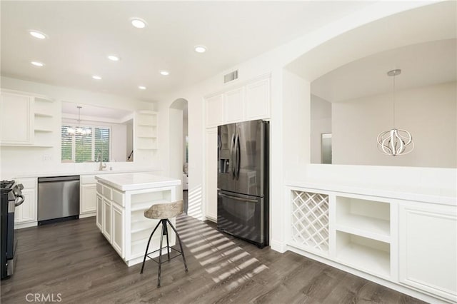 3120 Tara, Costa Mesa, CA 92626 - kitchen with open shelves, stainless steel appliances, a chandelier, arched walkways, and white cabinets