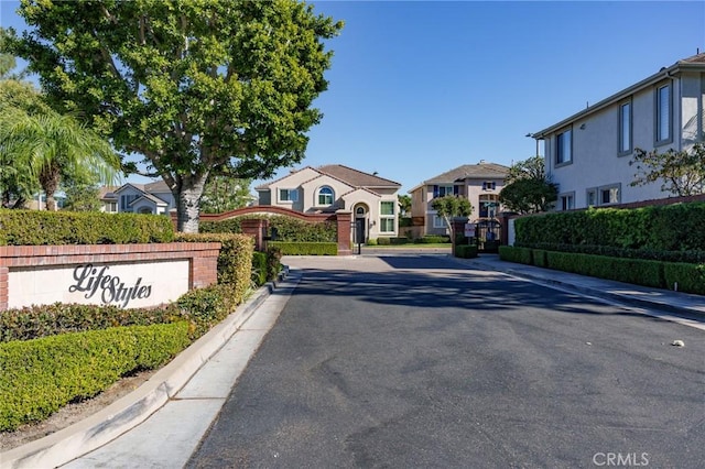 3120 Tara, Costa Mesa, CA 92626 - view of asphalt road featuring a residential view, curbs, and a gated entry