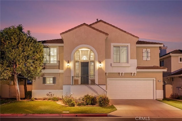 3120 Tara, Costa Mesa, CA 92626 - mediterranean / spanish home featuring concrete driveway, a front lawn, a tiled roof, a garage, and stucco siding
