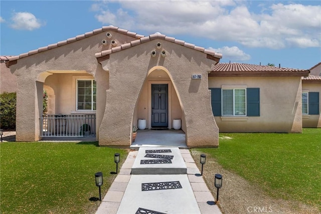 67760 Rio Vista Dr, Cathedral City, CA 92234 - mediterranean / spanish home with a front yard, a tile roof, and stucco siding