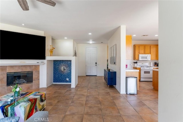 67760 Rio Vista Dr, Cathedral City, CA 92234 - living room with a ceiling fan, a tiled fireplace, and recessed lighting