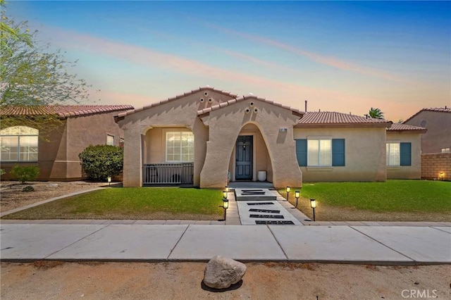 67760 Rio Vista Dr, Cathedral City, CA 92234 - mediterranean / spanish house with stucco siding, a front lawn, and a tiled roof