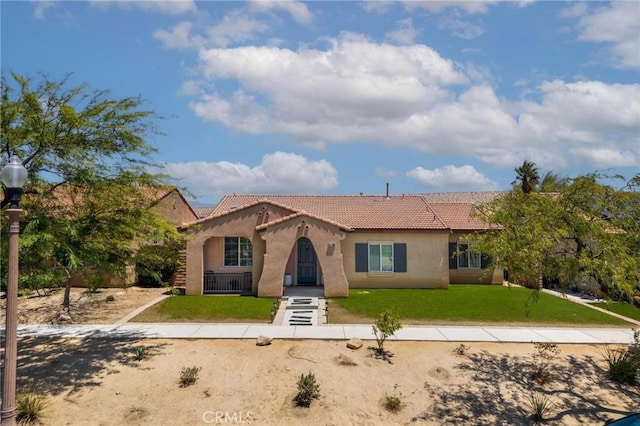 67760 Rio Vista Dr, Cathedral City, CA 92234 - mediterranean / spanish home featuring a tile roof, stucco siding, and a front yard