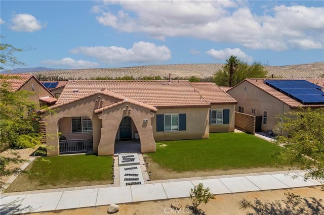 67760 Rio Vista Dr, Cathedral City, CA 92234 - mediterranean / spanish home featuring stucco siding, a tiled roof, a front lawn, and a mountain view