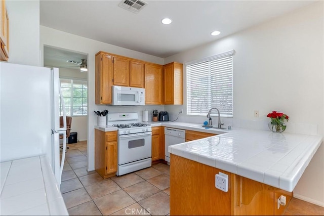 67760 Rio Vista Dr, Cathedral City, CA 92234 - kitchen with white appliances, a peninsula, recessed lighting, and light tile patterned flooring
