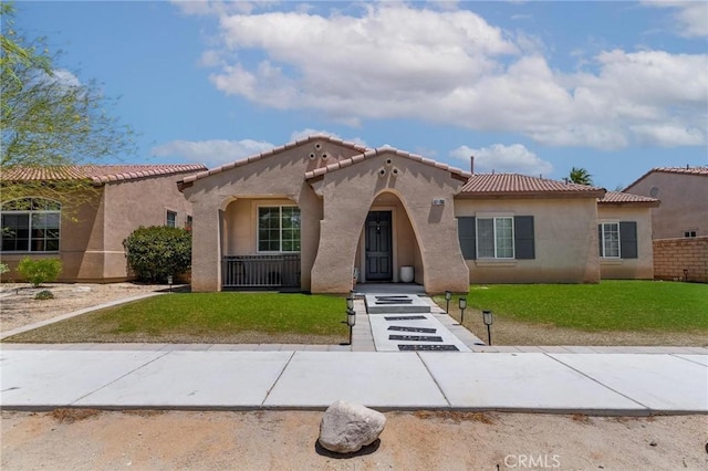 67760 Rio Vista Dr, Cathedral City, CA 92234 - mediterranean / spanish house with stucco siding, a front yard, and a tile roof