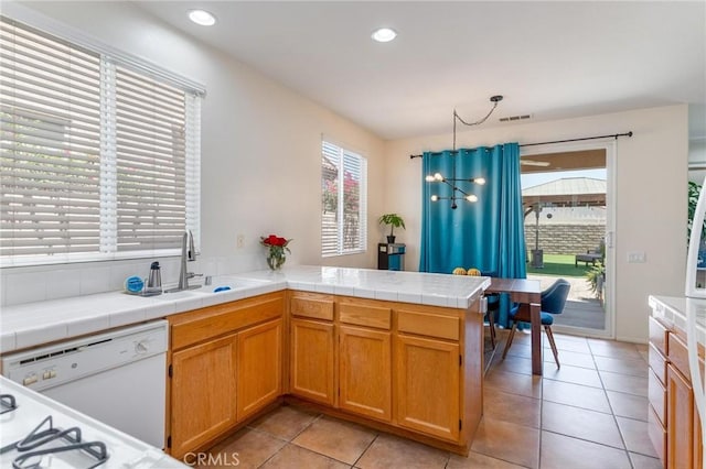 67760 Rio Vista Dr, Cathedral City, CA 92234 - kitchen featuring dishwasher, a peninsula, light tile patterned floors, tile counters, and recessed lighting