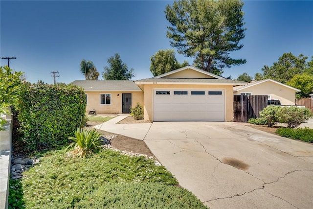 131 N Dommer Ave, Walnut, CA 91789 - ranch-style house featuring an attached garage, stucco siding, and driveway