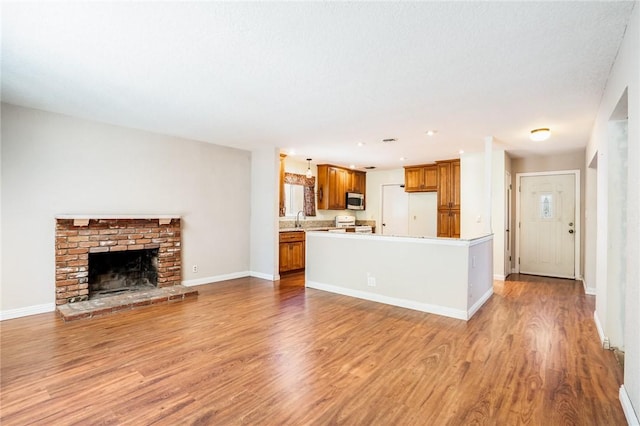 131 N Dommer Ave, Walnut, CA 91789 - unfurnished living room with light wood finished floors and a fireplace