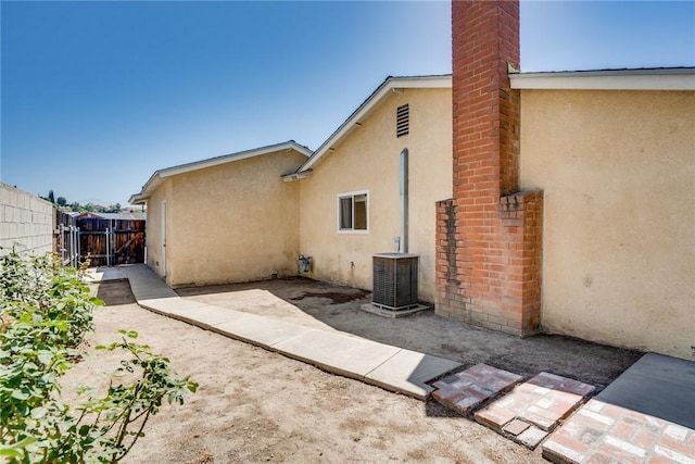 131 N Dommer Ave, Walnut, CA 91789 - back of property with stucco siding, a chimney, and a patio