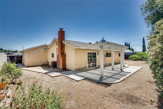 131 N Dommer Ave, Walnut, CA 91789 - back of house with a pergola, a fenced backyard, a patio area, stucco siding, and a chimney
