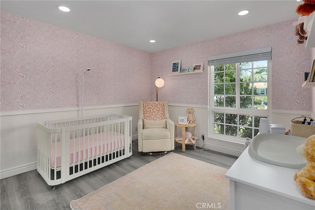 2861 Hillman St, Thousand Oaks, CA 91360 - bedroom featuring wallpapered walls, a wainscoted wall, recessed lighting, wood finished floors, and a nursery area