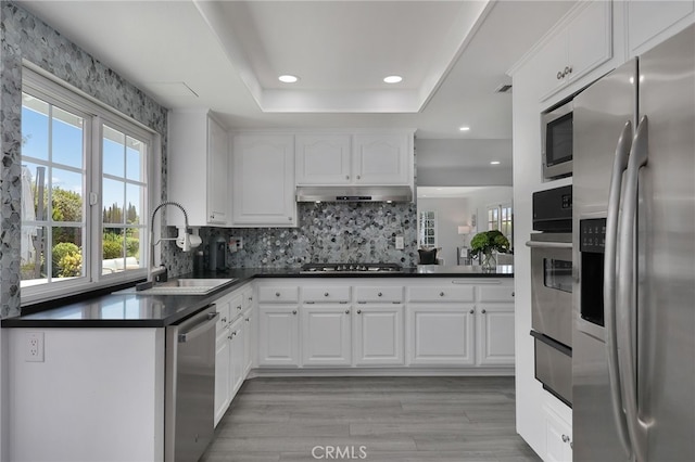 2861 Hillman St, Thousand Oaks, CA 91360 - kitchen with appliances with stainless steel finishes, dark countertops, recessed lighting, tasteful backsplash, and white cabinets