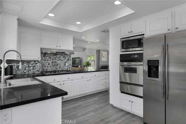 2861 Hillman St, Thousand Oaks, CA 91360 - kitchen featuring appliances with stainless steel finishes, a warming drawer, a raised ceiling, dark countertops, and recessed lighting