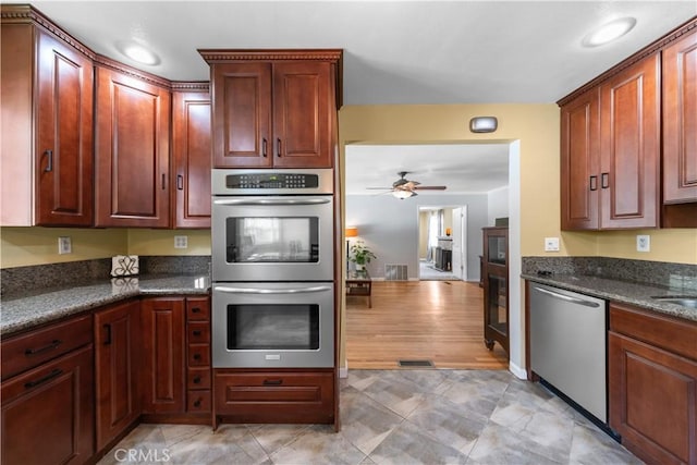 644 E Mountain View Ave, Glendora, CA 91741 - kitchen with stainless steel appliances, a ceiling fan, a fireplace with raised hearth, and dark stone countertops