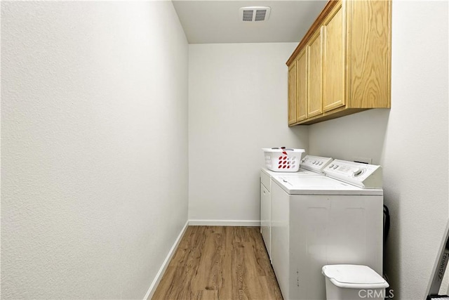 9790 Heatherhearst Dr, Chowchilla, CA 93610 - laundry area with washer and clothes dryer, cabinet space, and light wood-style floors