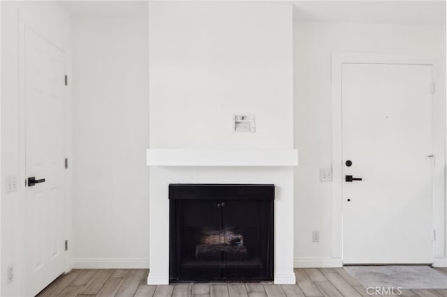 2827 S Fairview St Unit O, Santa Ana, CA 92704 - detailed view of wood finished floors and a fireplace