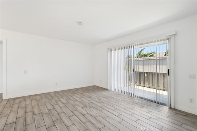 2827 S Fairview St Unit O, Santa Ana, CA 92704 - spare room with baseboards and light wood-style floors