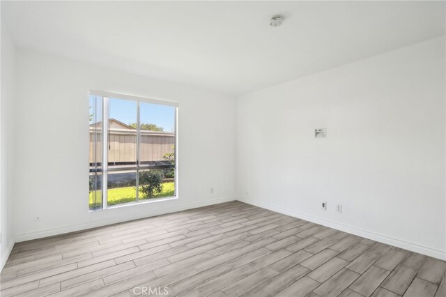 2827 S Fairview St Unit O, Santa Ana, CA 92704 - spare room featuring wood finished floors and a smoke detector