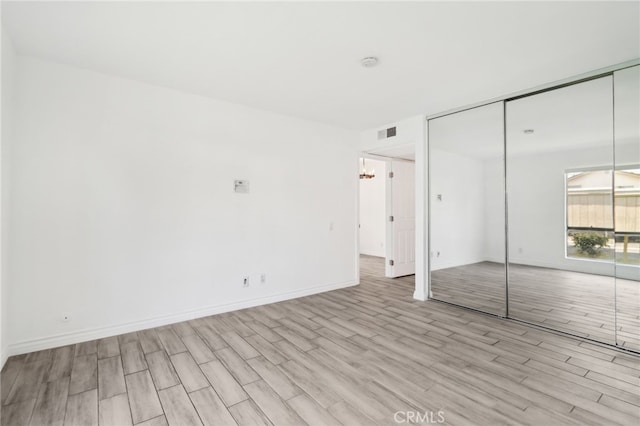 2827 S Fairview St Unit O, Santa Ana, CA 92704 - unfurnished bedroom featuring wood finished floors and a closet