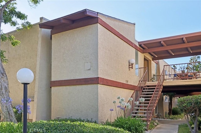 1010 W Macarthur Blvd Unit 24, Santa Ana, CA 92707 - view of home's exterior with stairway, stucco siding, and a deck