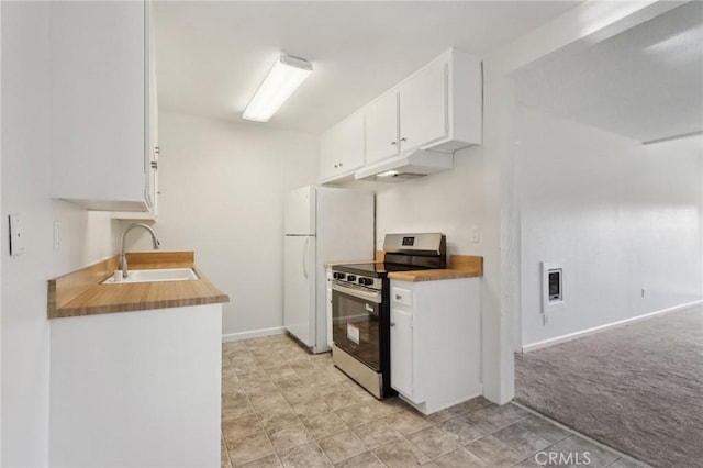 1010 W Macarthur Blvd Unit 24, Santa Ana, CA 92707 - kitchen featuring stainless steel electric range oven, freestanding refrigerator, white cabinets, under cabinet range hood, and light colored carpet