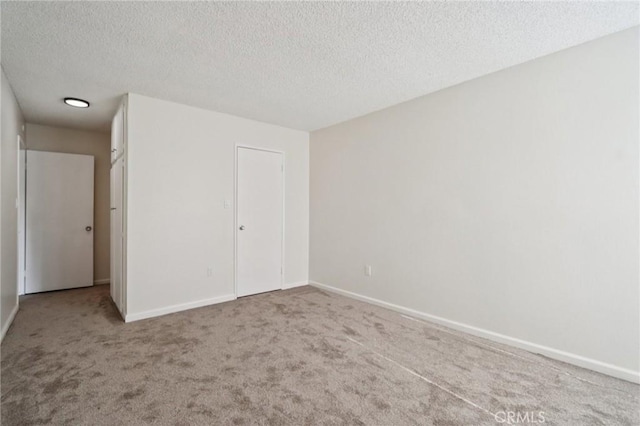 1010 W Macarthur Blvd Unit 24, Santa Ana, CA 92707 - carpeted spare room with a textured ceiling and baseboards