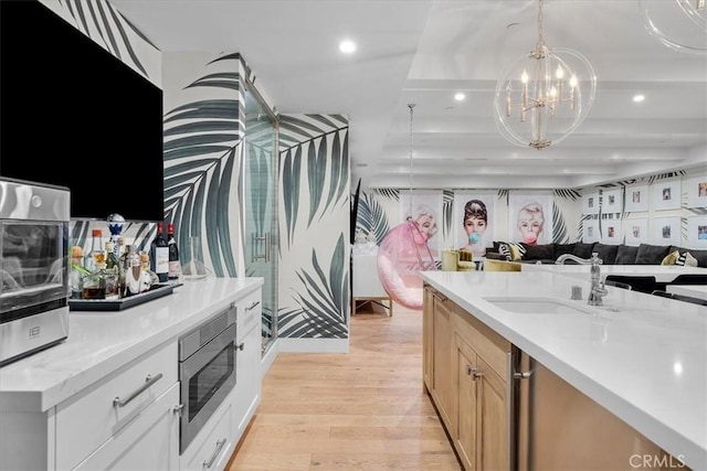 910 28th St, Manhattan Beach, CA 90266 - kitchen featuring stainless steel microwave, open floor plan, a chandelier, light wood-style flooring, and recessed lighting