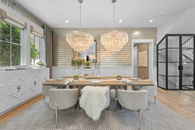 910 28th St, Manhattan Beach, CA 90266 - dining room with a chandelier, light wood-type flooring, a wainscoted wall, and a decorative wall
