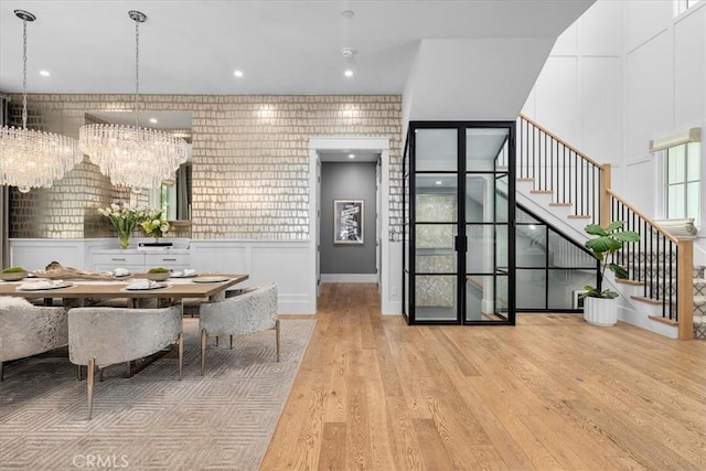 910 28th St, Manhattan Beach, CA 90266 - dining room featuring stairs, a chandelier, wood finished floors, and a decorative wall