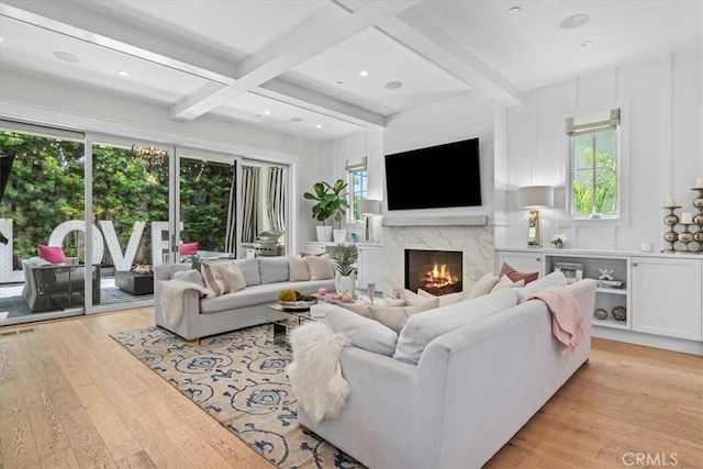 910 28th St, Manhattan Beach, CA 90266 - living area featuring light wood-type flooring, a premium fireplace, plenty of natural light, and beamed ceiling