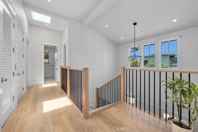 910 28th St, Manhattan Beach, CA 90266 - hallway featuring hardwood / wood-style flooring, a skylight, an upstairs landing, and recessed lighting