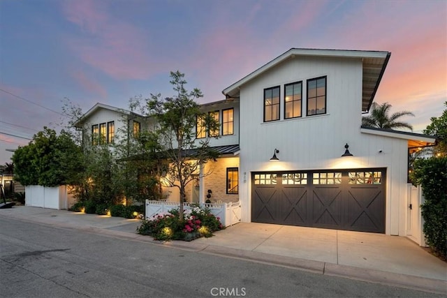 910 28th St, Manhattan Beach, CA 90266 - view of front of home featuring an attached garage, a standing seam roof, a metal roof, and driveway