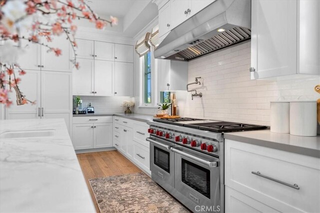 910 28th St, Manhattan Beach, CA 90266 - kitchen featuring range with two ovens, under cabinet range hood, and white cabinets
