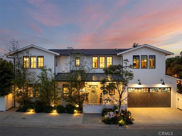 910 28th St, Manhattan Beach, CA 90266 - view of front of property featuring a standing seam roof, a garage, driveway, and a metal roof