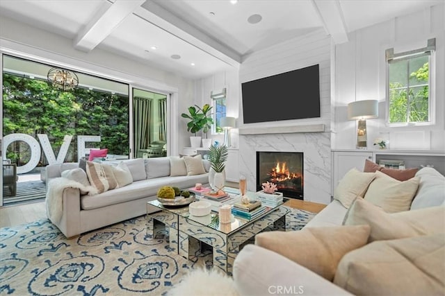 910 28th St, Manhattan Beach, CA 90266 - living area with wood finished floors, beam ceiling, a high end fireplace, and a chandelier