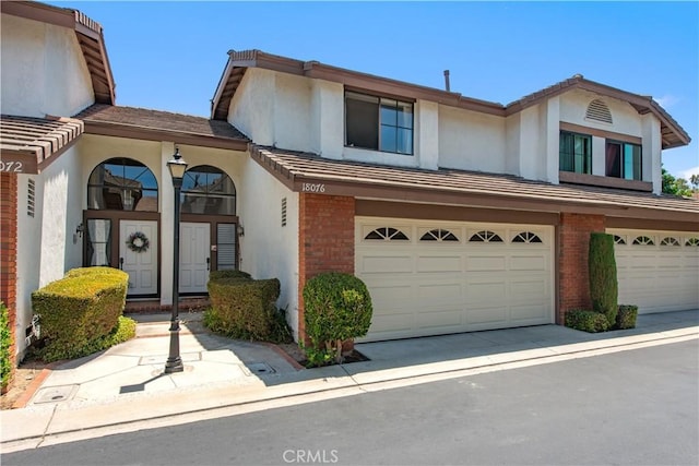 18076 Courreges Ct, Fountain Valley, CA 92708 - view of front of house featuring brick siding, stucco siding, and an attached garage