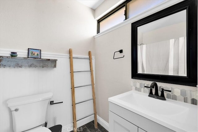 5616 Cahuilla Ave Unit 29, Palms, CA 92277 - bathroom with vanity, backsplash, and wainscoting