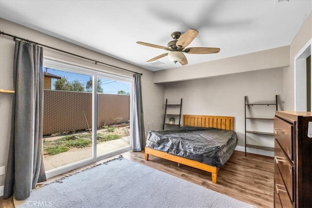 5616 Cahuilla Ave Unit 29, Palms, CA 92277 - bedroom with access to exterior, wood finished floors, and a ceiling fan