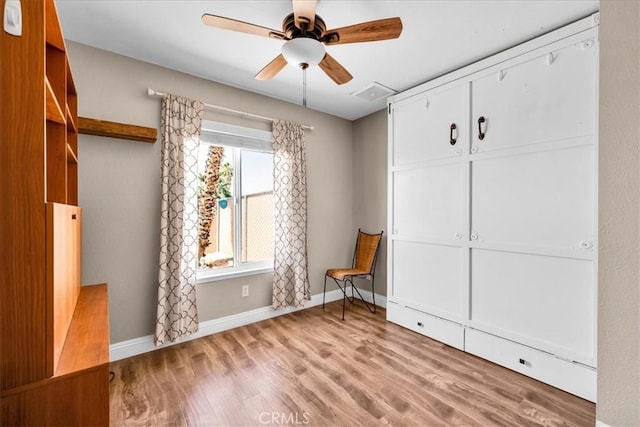 5616 Cahuilla Ave Unit 29, Palms, CA 92277 - unfurnished bedroom with wood finished floors and ceiling fan