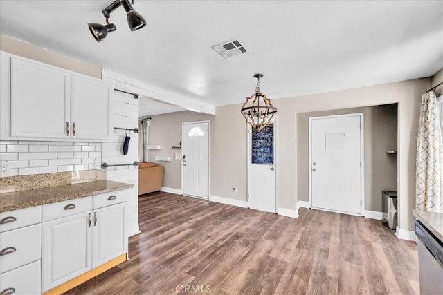 5616 Cahuilla Ave Unit 29, Palms, CA 92277 - kitchen with decorative backsplash, white cabinets, a chandelier, stainless steel dishwasher, and wood finished floors