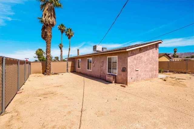 5616 Cahuilla Ave Unit 29, Palms, CA 92277 - back of house with stucco siding, a fenced backyard, and a patio area