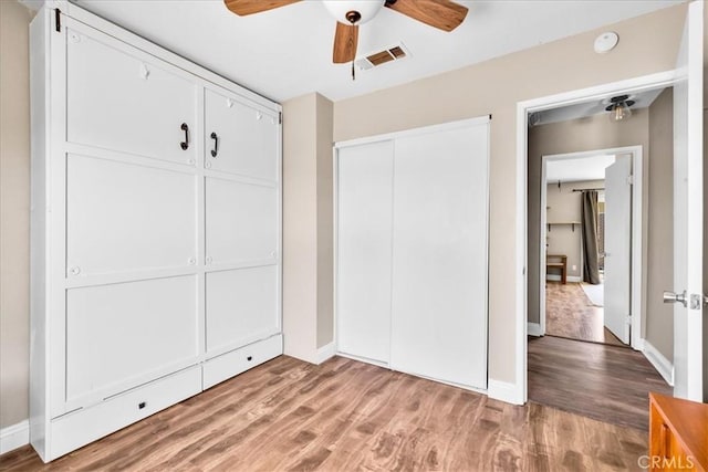 5616 Cahuilla Ave Unit 29, Palms, CA 92277 - unfurnished bedroom with light wood-type flooring, a closet, and ceiling fan