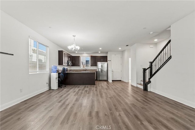 4429 La Joya Dr, Guadalupe, CA 93434 - kitchen with stainless steel appliances, open floor plan, dark brown cabinetry, a chandelier, and light countertops