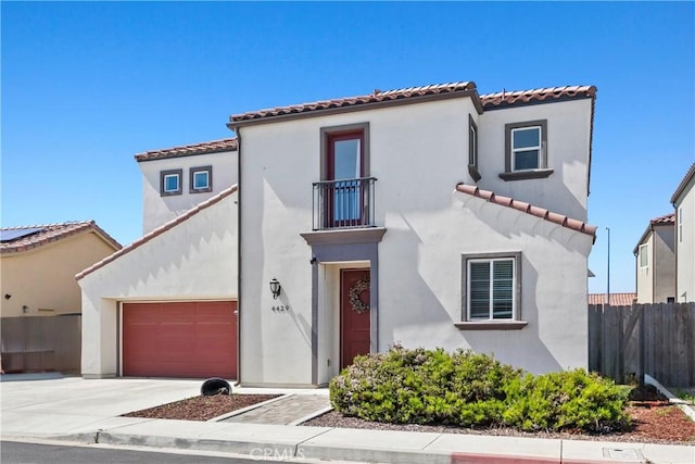 4429 La Joya Dr, Guadalupe, CA 93434 - mediterranean / spanish house featuring a balcony, a tile roof, concrete driveway, stucco siding, and an attached garage