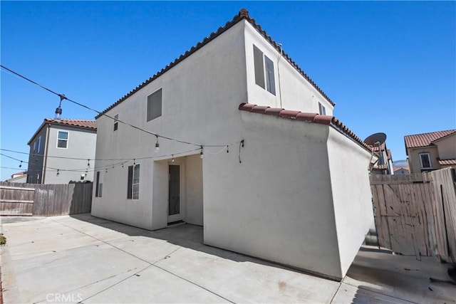 4429 La Joya Dr, Guadalupe, CA 93434 - rear view of house featuring a tile roof, a patio, stucco siding, and a fenced backyard