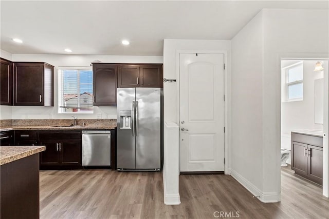 4429 La Joya Dr, Guadalupe, CA 93434 - kitchen featuring stainless steel appliances, dark brown cabinets, light wood-type flooring, light stone countertops, and recessed lighting