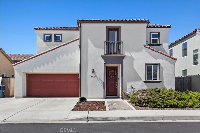 4429 La Joya Dr, Guadalupe, CA 93434 - mediterranean / spanish house with a tiled roof, a balcony, concrete driveway, stucco siding, and an attached garage