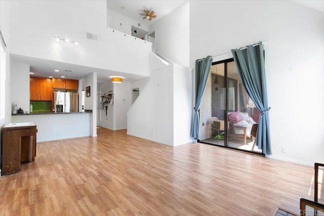 2224 River Run Dr Unit 154, San Diego, CA 92108 - unfurnished living room with a towering ceiling and light wood-style flooring